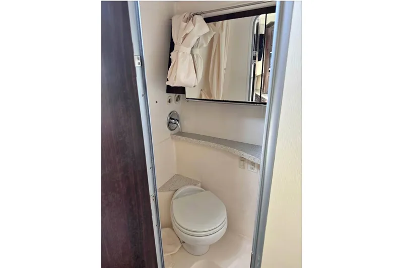 Slide: The Image of Bathroom interior of 2018 Regal 28 Express boat with toilet and mirror. - 11