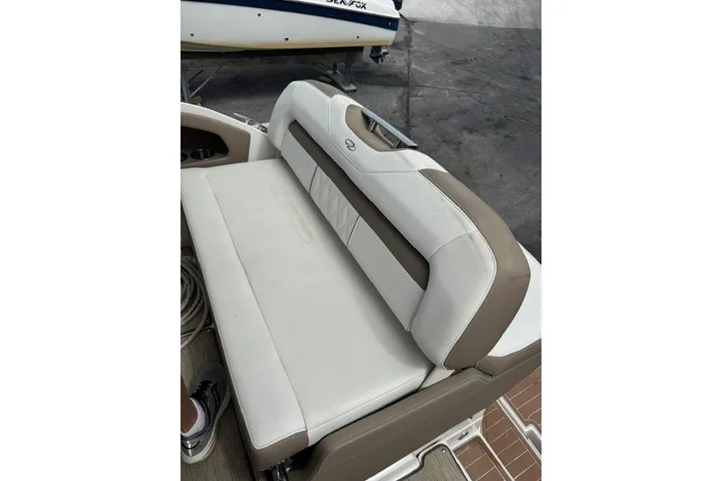 Slide: The Image of 2018 Regal 28 Express boat interior with beige and white seating. - 7