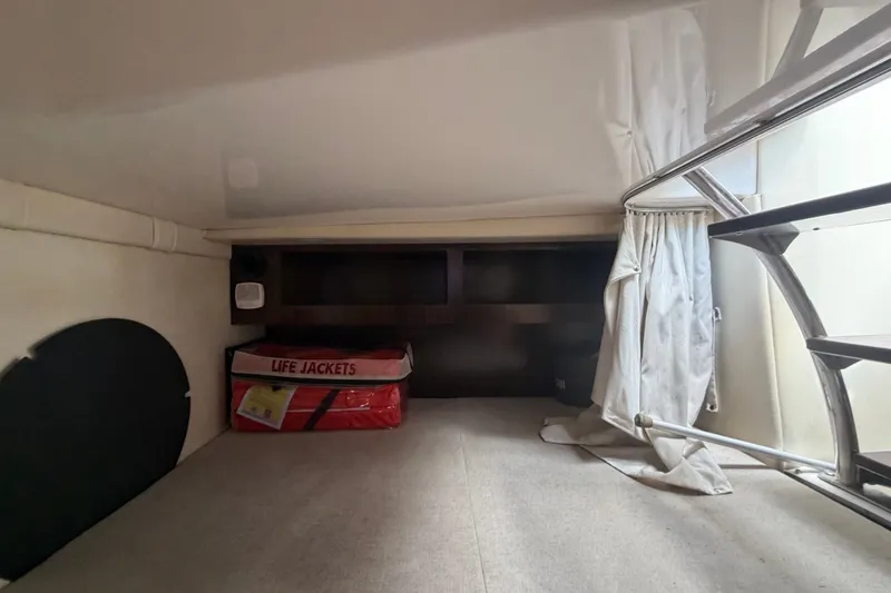 Slide: The Image of Interior cabin of 2018 Regal 28 Express boat with life jackets stored. - 94