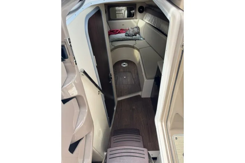 Slide: The Image of Interior of 2018 Regal 28 Express boat with cozy seating and wood flooring. - 16