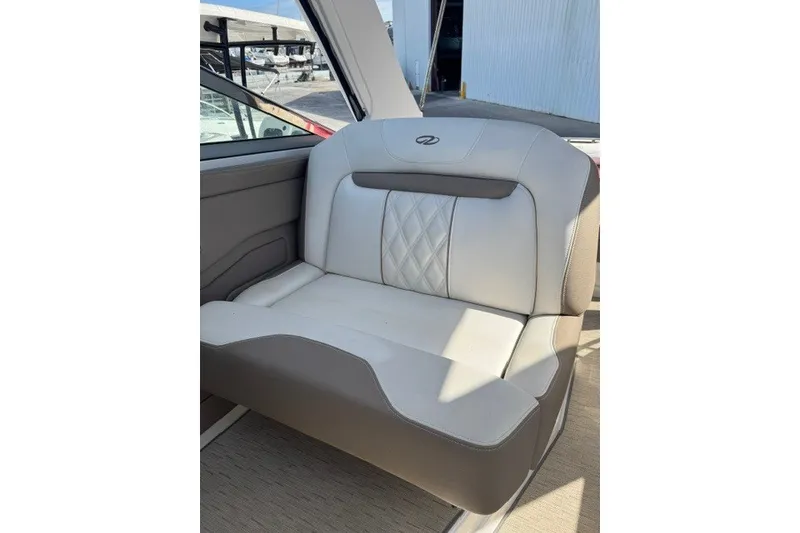 Slide: The Image of 2018 Regal 28 Express boat seat with elegant white and gray upholstery. - 6