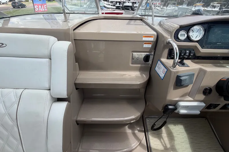 Slide: The Image of 2018 Regal 28 Express boat interior with helm, steps, and seating, for sale. - 44