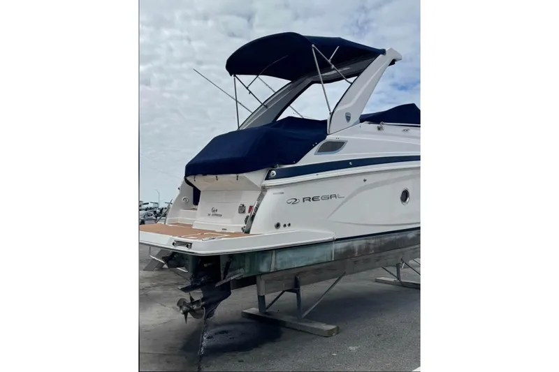 Slide: The Image of 2018 Regal 28 Express boat with blue canopy on a trailer. - 5