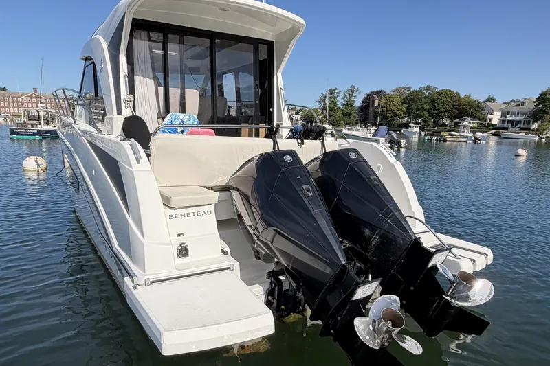 Slide: The Image of 2021 Beneteau Antares 27 boat with dual outboard motors docked in a marina. - 7