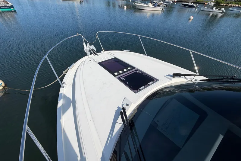 Slide: The Image of 2021 Beneteau Antares 27 boat on calm water, showcasing sleek deck design. - 36