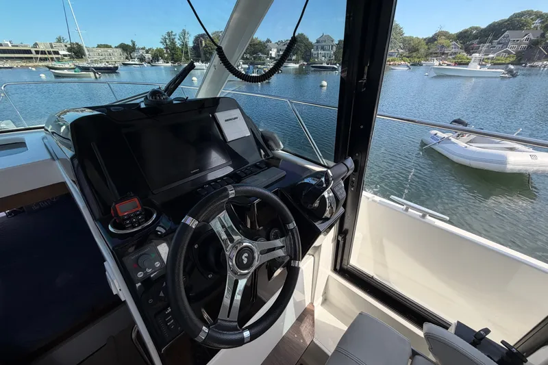 Slide: The Image of Interior helm of 2021 Beneteau Antares 27 with waterfront view. - 20
