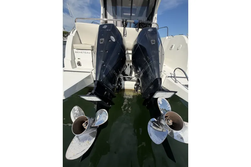 Slide: The Image of Twin outboard motors on a 2021 Beneteau Antares 27 boat, docked in water. - 45