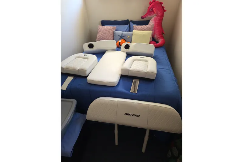 Slide: The Image of 2021 Sea Pro 228 Bay boat cushions on a blue bed with plush toys. - 36