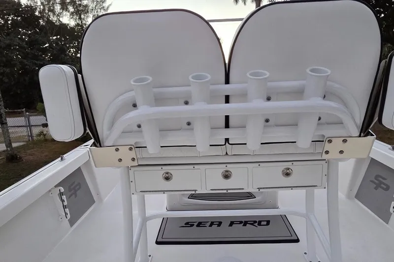 Slide: The Image of 2021 Sea Pro 228 Bay boat interior with rod holders and storage compartments. - 22