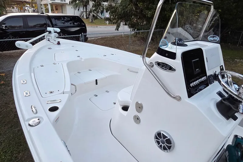 Slide: The Image of 2021 Sea Pro 228 Bay boat interior with steering console and seating area. - 19