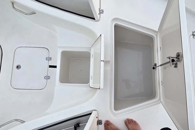 Slide: The Image of 2021 Sea Pro 228 Bay boat storage compartments and hatches, open view. - 28