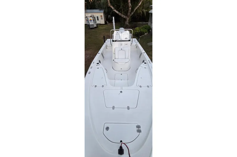 Slide: The Image of 2021 Sea Pro 228 Bay boat interior, featuring spacious deck and seating arrangement. - 35