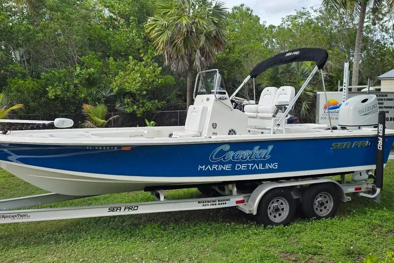 Slide: The Image of 2021 Sea Pro 228 Bay boat on trailer, featuring Coastal Marine Detailing branding. - 16