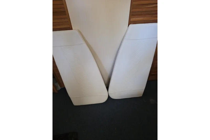 Slide: The Image of White boat cushions for 2021 Sea Pro 228 Bay, leaning against a wall. - 17