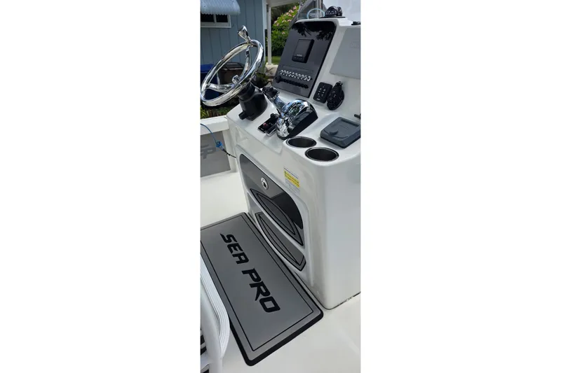 Slide: The Image of 2021 Sea Pro 228 Bay boat console with steering wheel and controls. - 14