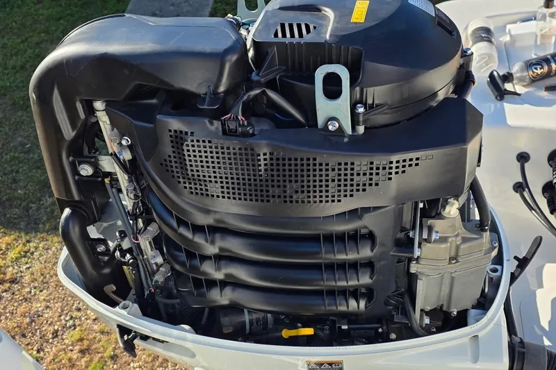 Slide: The Image of 2021 Sea Pro 228 Bay boat engine close-up, showcasing intricate mechanical details. - 24