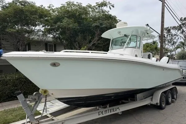 The Image of 2006 Everglades 290 Center Console boat on trailer, parked outdoors. - 0