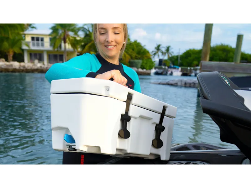 Slide: The Image of A person secures a white box on a Sea-Doo GTR 230 jet ski by the water. - 7