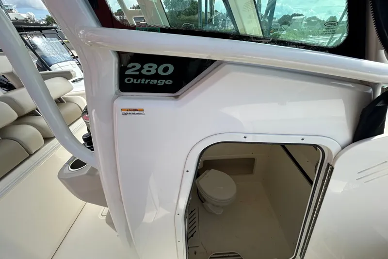 Slide: The Image of 2020 Boston Whaler 280 Outrage boat interior with cabin door and seating area. - 16