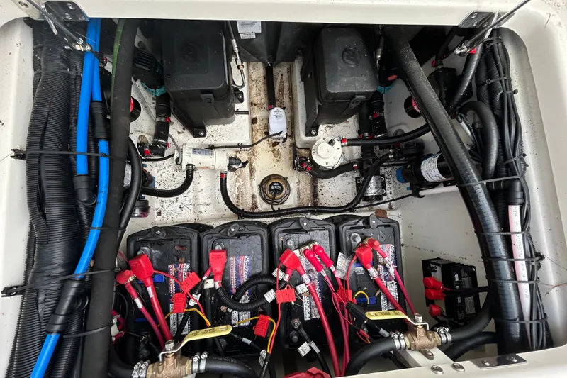 Slide: The Image of Battery compartment of a 2020 Boston Whaler 280 Outrage, showcasing wiring and components. - 26