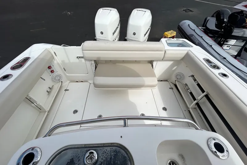 Slide: The Image of 2020 Boston Whaler 280 Outrage boat interior with dual Mercury engines and seating area. - 24