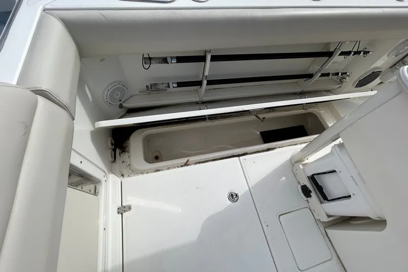 Slide: The Image of 2020 Boston Whaler 280 Outrage interior storage compartment with open hatch. - 18