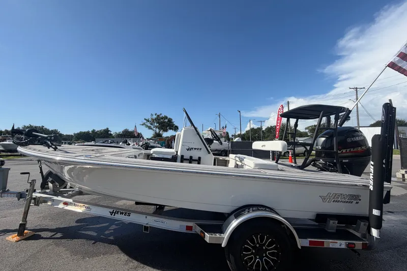 Slide: The Image of 2022 Hewes Redfisher 16 boat on trailer, displayed outdoors under clear sky. - 8