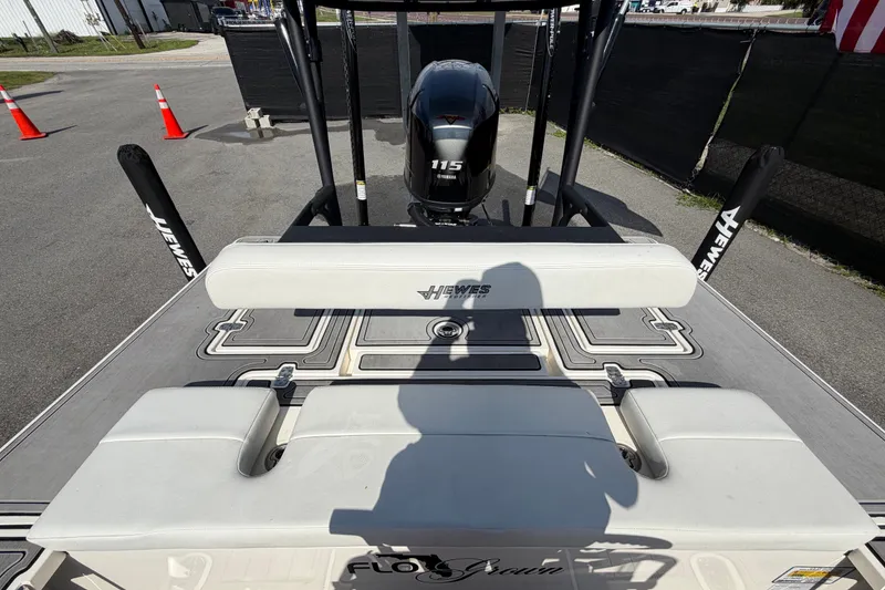 Slide: The Image of 2022 Hewes Redfisher 16 boat with Yamaha 115 engine, docked with visible seating and flooring. - 44