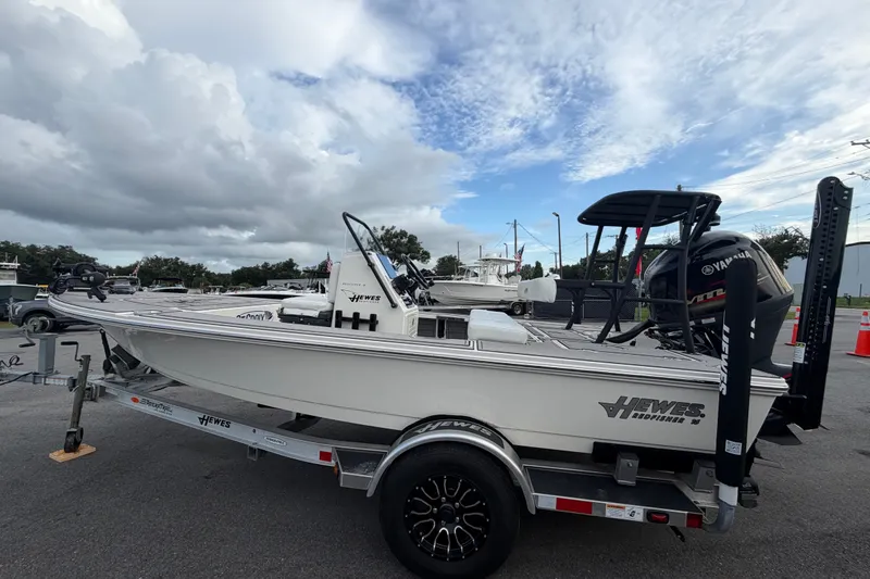 Slide: The Image of 2022 Hewes Redfisher 16 boat on trailer, under cloudy sky, with Yamaha engine. - 5
