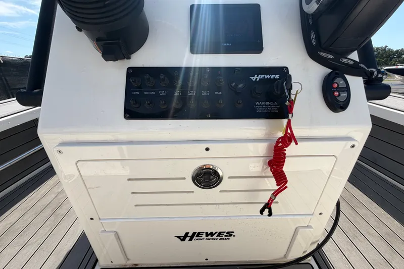 Slide: The Image of 2022 Hewes Redfisher 16 boat console with controls and safety features. - 24