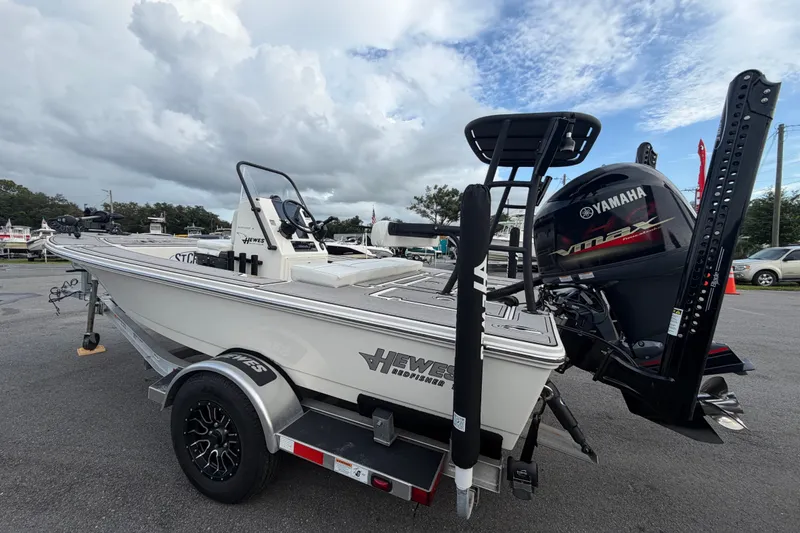 Slide: The Image of 2022 Hewes Redfisher 16 boat with Yamaha engine on trailer, parked outdoors. - 4