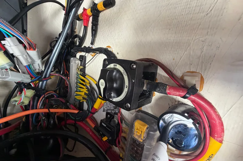 Slide: The Image of Electrical wiring and switch panel inside a 2022 Hewes Redfisher 16 boat. - 26