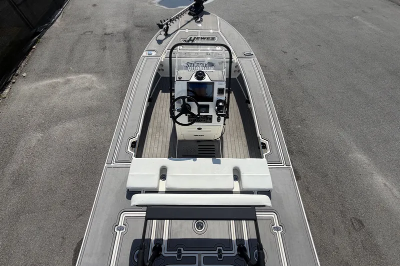 Slide: The Image of 2022 Hewes Redfisher 16 boat interior with steering console and seating. - 13