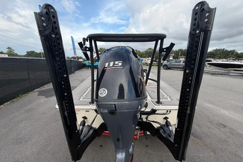 Slide: The Image of 2022 Hewes Redfisher 16 boat with Yamaha 115 engine, parked outdoors. - 2