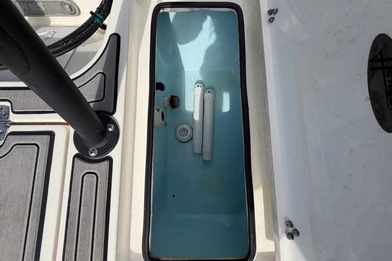 Slide: The Image of 2022 Hewes Redfisher 16 boat storage compartment with light blue interior and black trim. - 55
