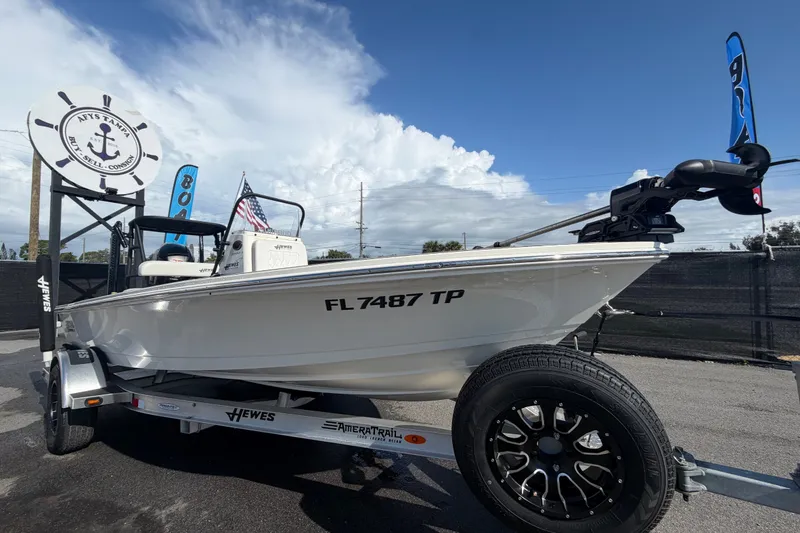 The Image of 2022 Hewes Redfisher 16 boat on trailer, displayed outdoors with clear sky. - 0