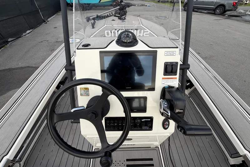 Slide: The Image of 2022 Hewes Redfisher 16 boat console with steering wheel and navigation display. - 8