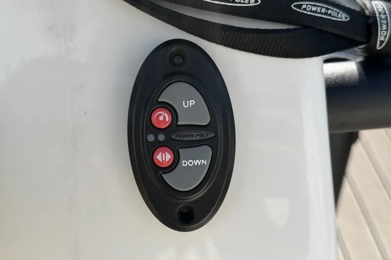 Slide: The Image of Power-Pole control panel on 2022 Hewes Redfisher 16 boat, featuring up and down buttons. - 23