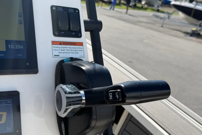 Slide: The Image of Control panel of a 2022 Hewes Redfisher 16 boat with throttle and warning label. - 22