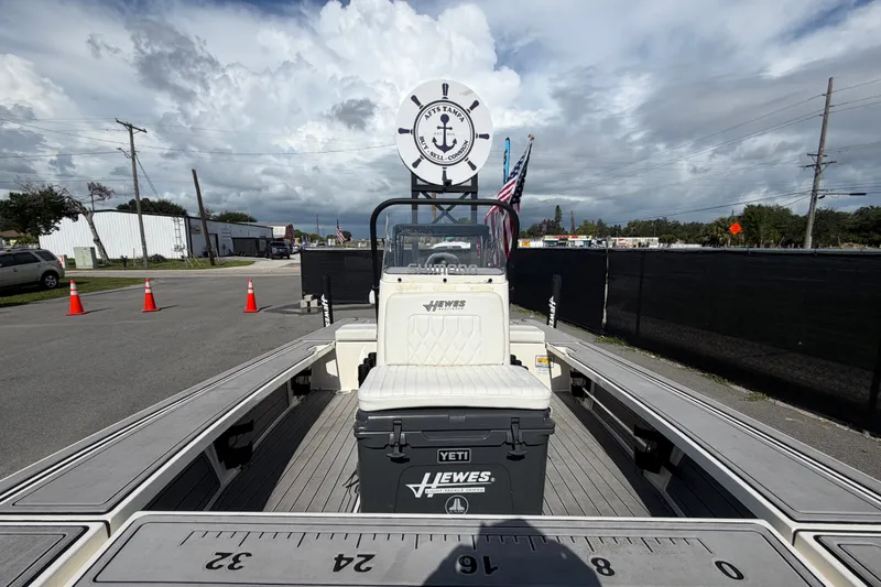 Slide: The Image of 2022 Hewes Redfisher 16 boat with Yeti cooler, parked outdoors under cloudy sky. - 37