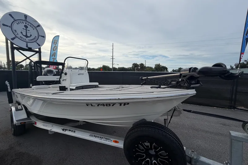The Image of 2022 Hewes Redfisher 16 boat on trailer, displayed outdoors with sale signage. - 0