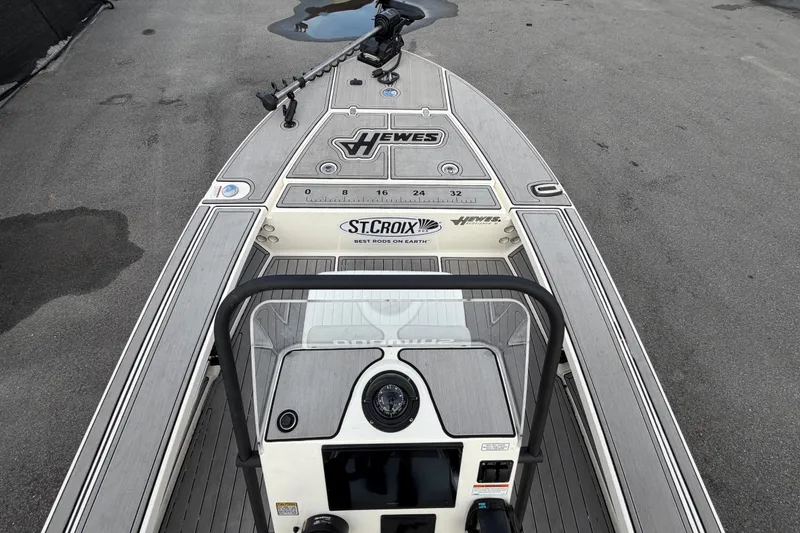 Slide: The Image of 2022 Hewes Redfisher 16 boat deck with steering console and branding. - 9