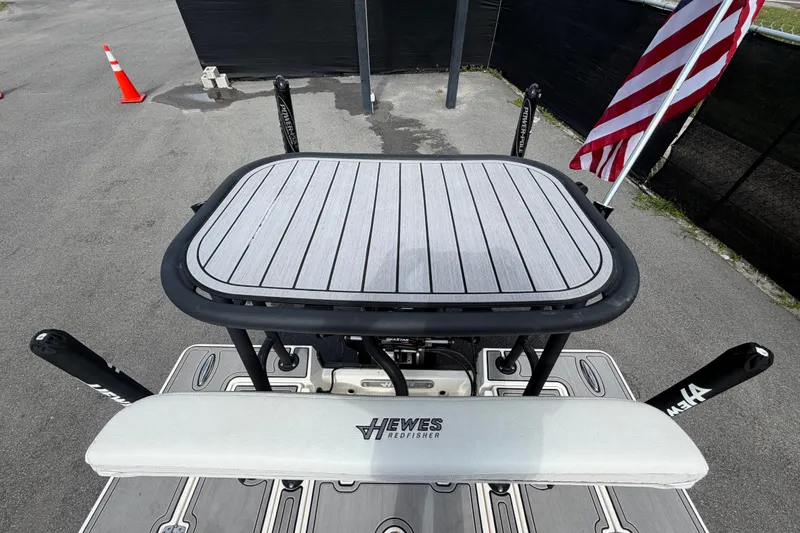 Slide: The Image of 2022 Hewes Redfisher 16 boat deck with American flag and fishing equipment. - 57