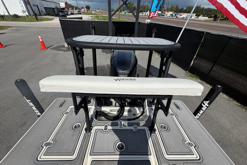 Slide: The Image of 2022 Hewes Redfisher 16 boat with custom deck and seating, displayed outdoors. - 48