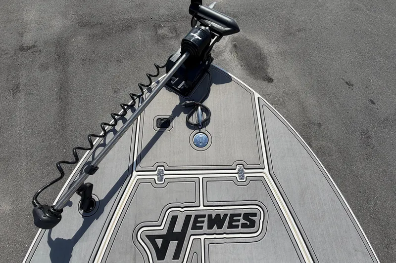 Slide: The Image of 2022 Hewes Redfisher 16 boat deck with trolling motor and logo. - 32