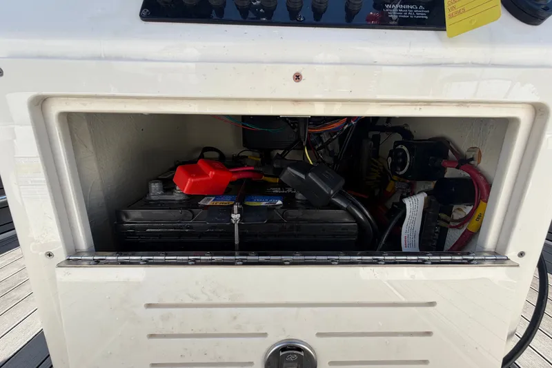 Slide: The Image of Battery compartment of a 2022 Hewes Redfisher 16 boat, showing wiring and connections. - 25