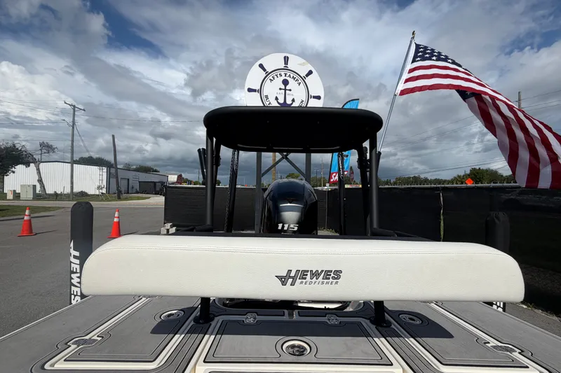Slide: The Image of 2022 Hewes Redfisher 16 boat with American flag, outdoor display. - 46