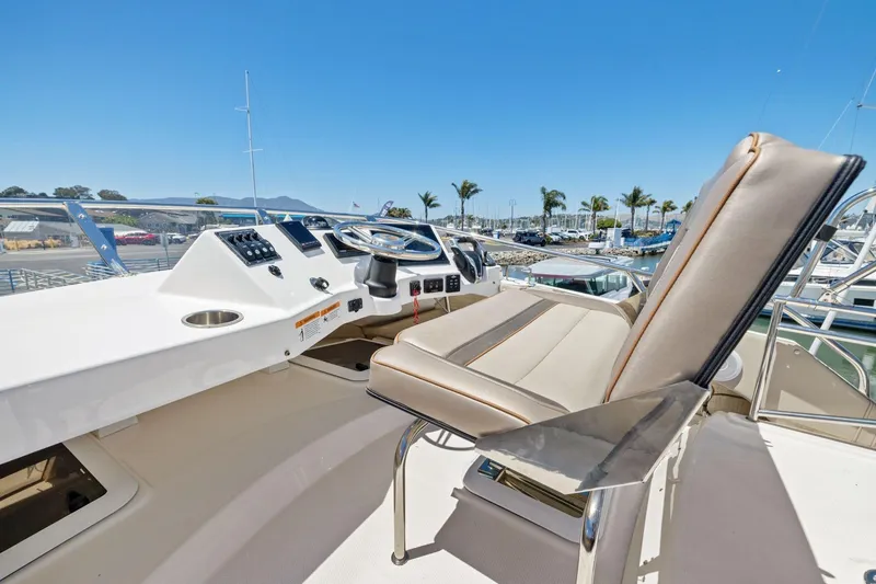 Slide: The Image of 2022 Cutwater C-32 CB boat helm with steering wheel and captain's chair. - 16