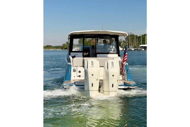 Slide: The Image of 2025 MJM 4 boat with dual 600 V12 engines cruising on a sunny day. - 6