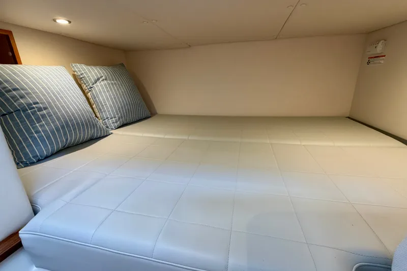 Slide: The Image of 2025 MJM 4 interior cabin with striped pillows and cushioned bed. - 40